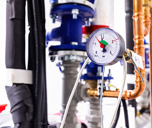 pressure gauge displaying measurement on piping system for fluid mechanics and pressure design featuring six bar indicator