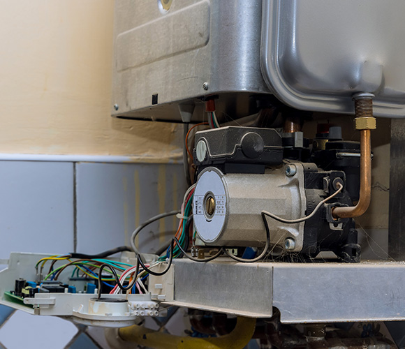 internal components of a water heater featuring wiring motor and pipes with three connection points